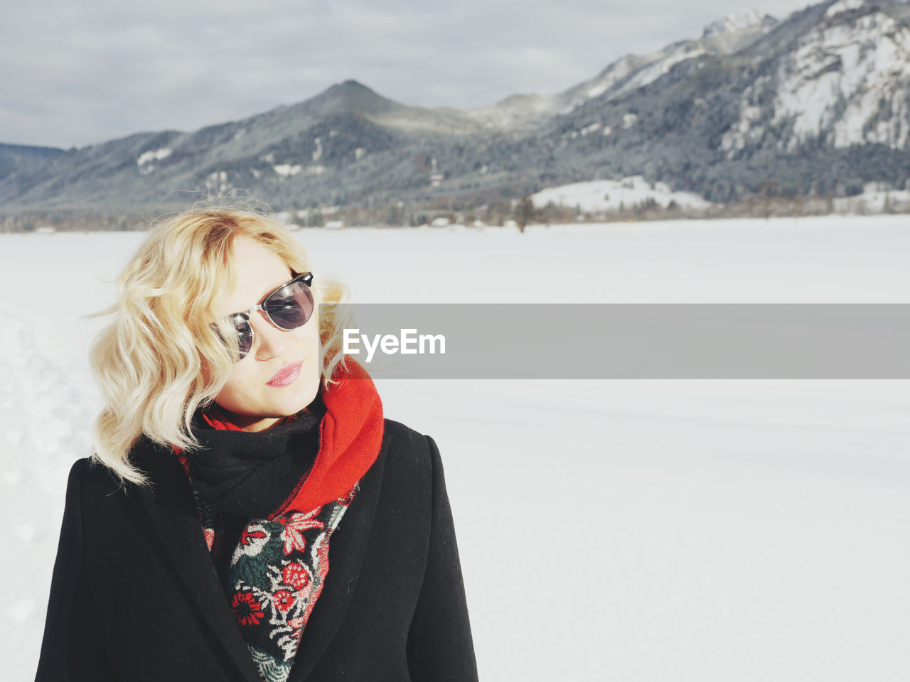 Young woman standing on snow covered landscape