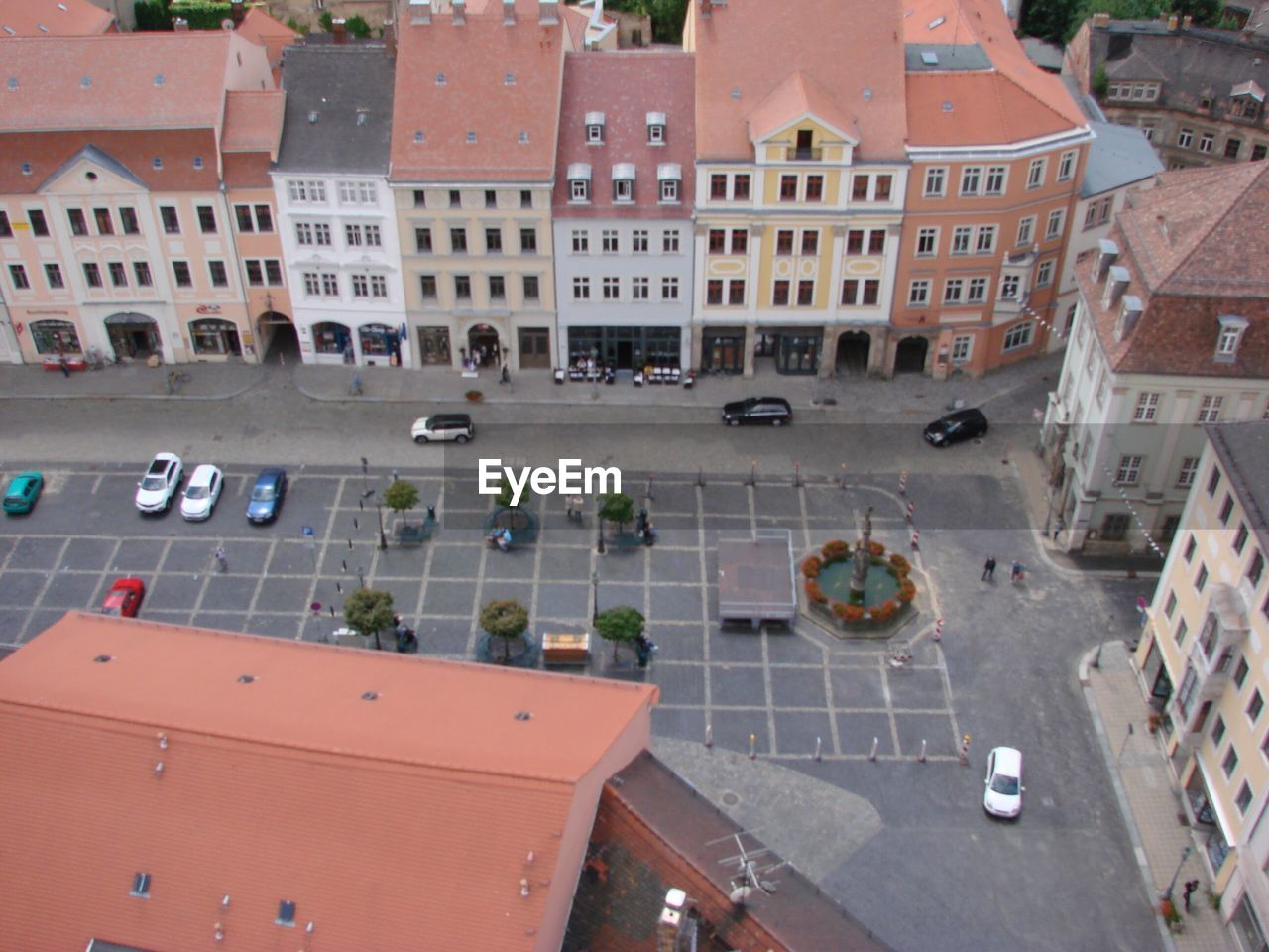 HIGH ANGLE VIEW OF VEHICLES ON ROAD BY BUILDINGS