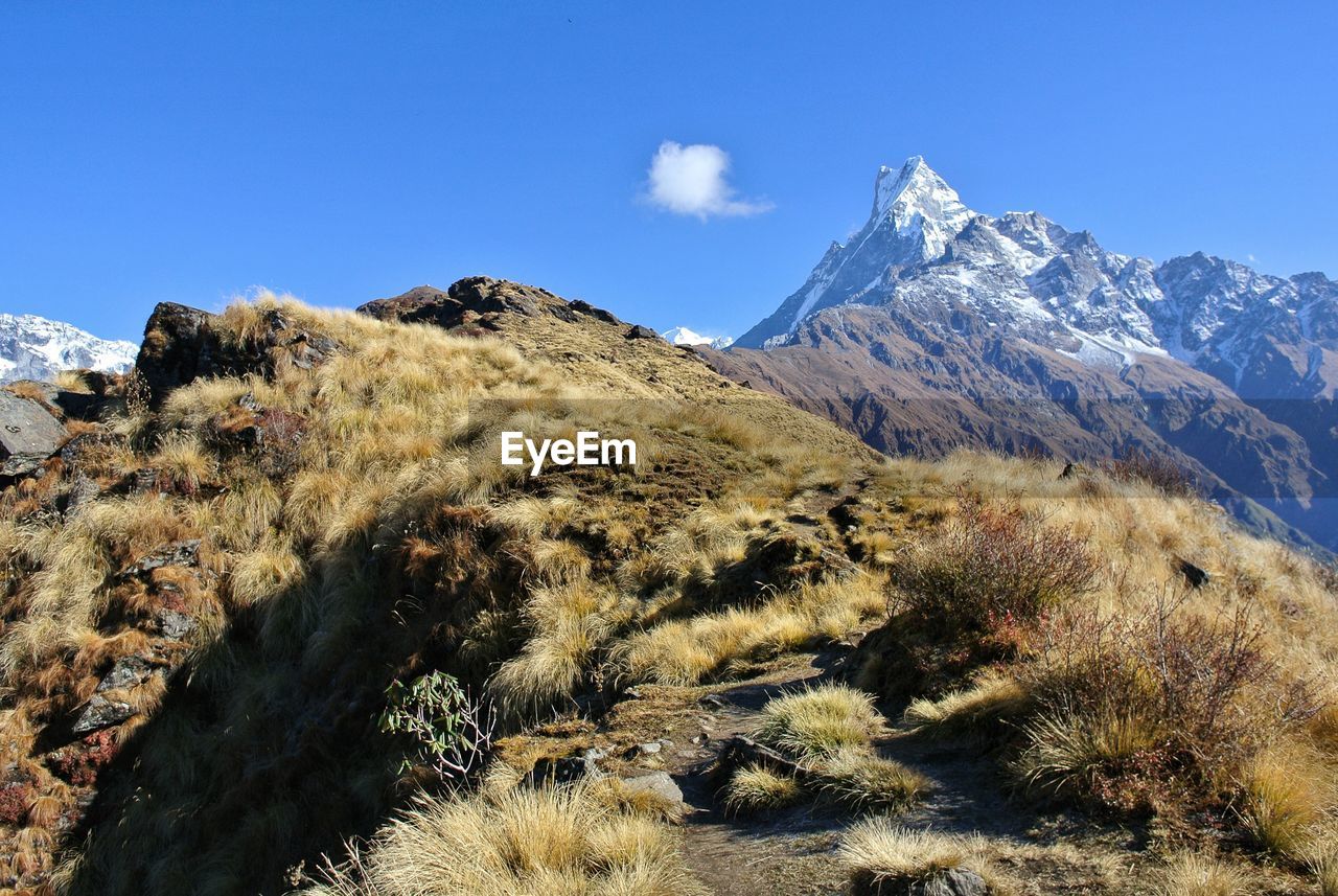 SCENIC VIEW OF MOUNTAINS AGAINST BLUE SKY