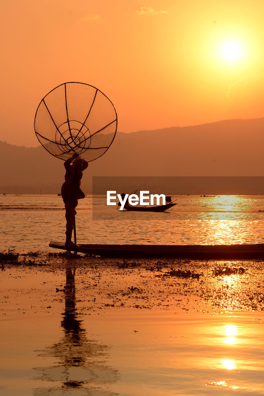 Silhouette of people at sunset