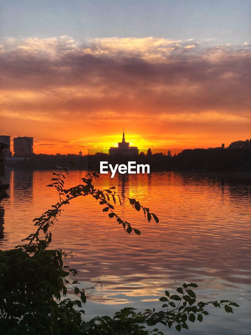 SCENIC VIEW OF LAKE AGAINST ORANGE SKY