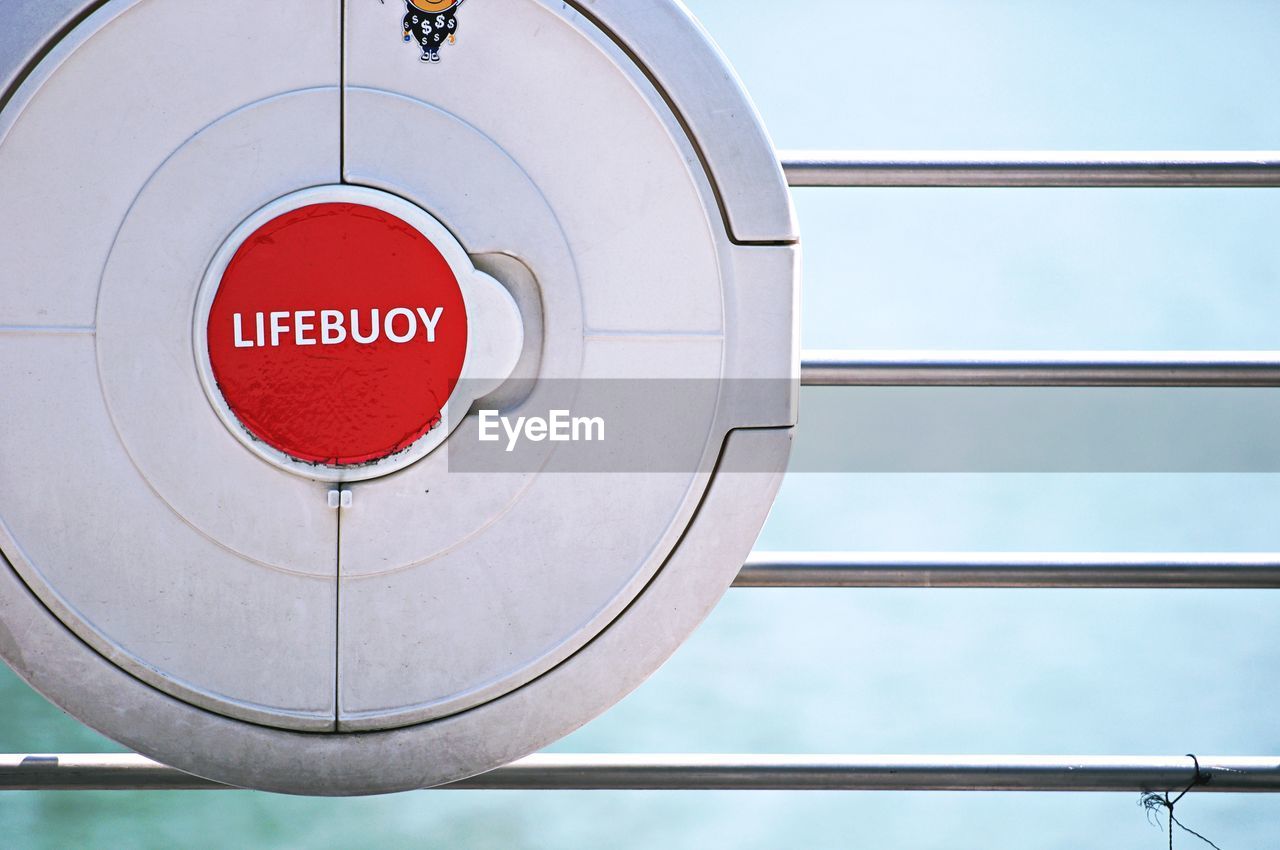 sign, communication, circle, geometric shape, shape, red, no people, warning sign, text, architecture, wheel, day, stop sign, road sign, western script, close-up, protection, railing, metal, security
