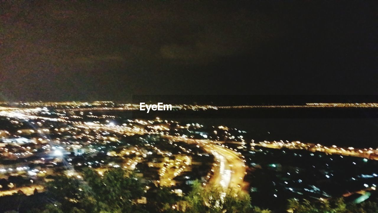 VIEW OF ILLUMINATED CITY AT NIGHT