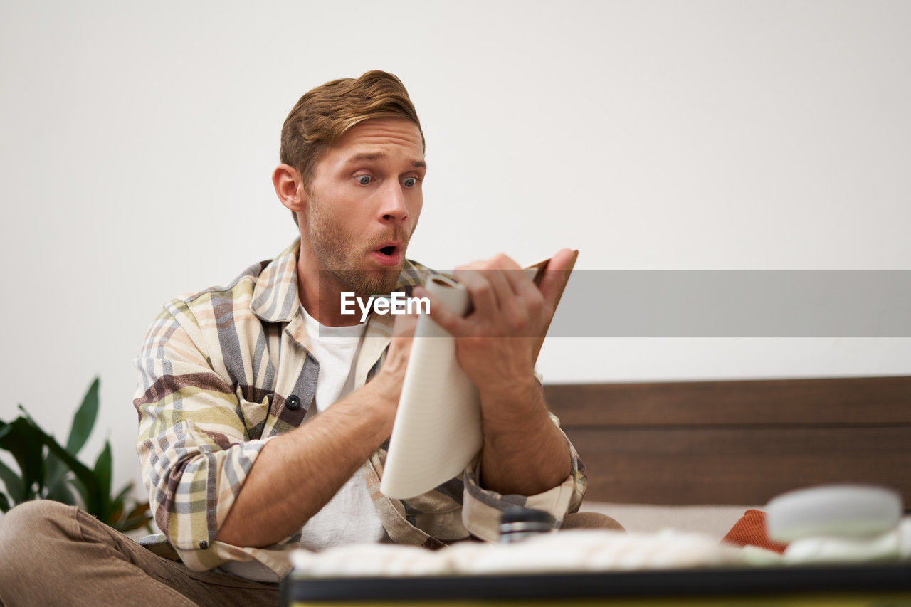 portrait of young man using mobile phone