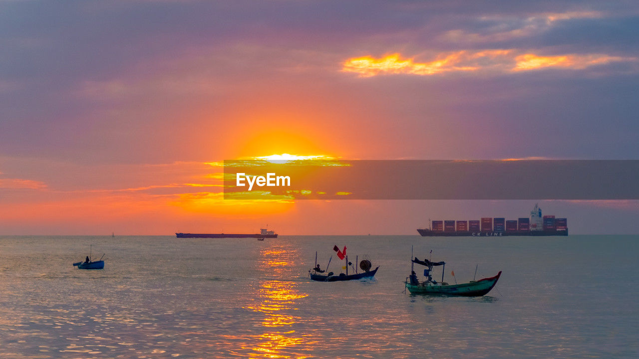 water, nautical vessel, transportation, sky, sea, sunset, mode of transportation, cloud, nature, beauty in nature, ocean, boat, vehicle, travel, horizon, scenics - nature, sun, orange color, shore, horizon over water, watercraft, ship, outdoors, tranquility, travel destinations, dusk, occupation, sailing, beach, sunlight, silhouette, tranquil scene, evening, holiday, coast, idyllic, afterglow, seascape, architecture, tourism, vacation, motion, environment, wave, land, dramatic sky, bay, trip, group of people