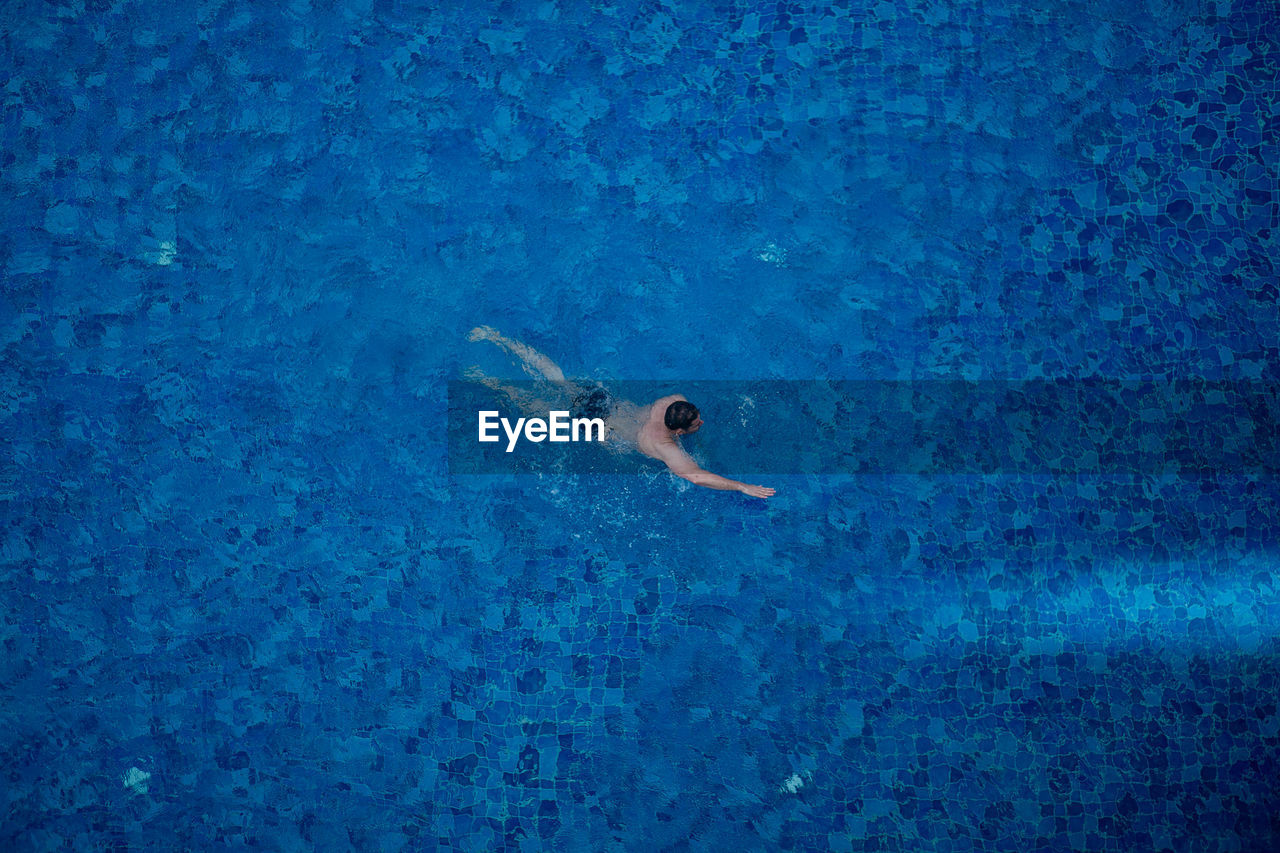 High angle view of man swimming in pool