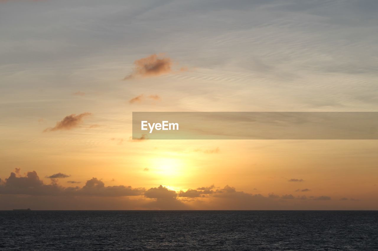 SEA AGAINST SKY AT SUNSET