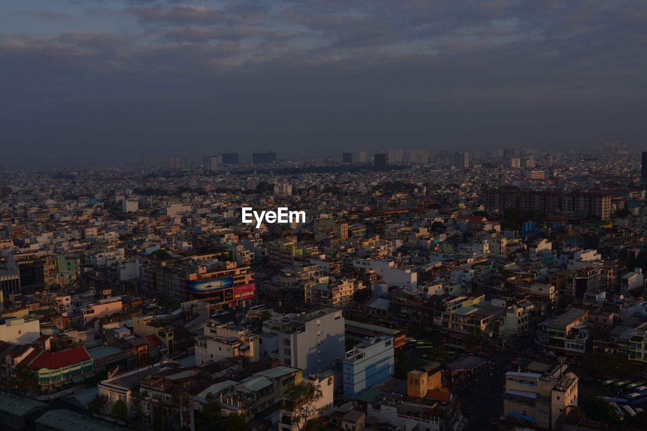 High angle view of illuminated buildings against sky in city