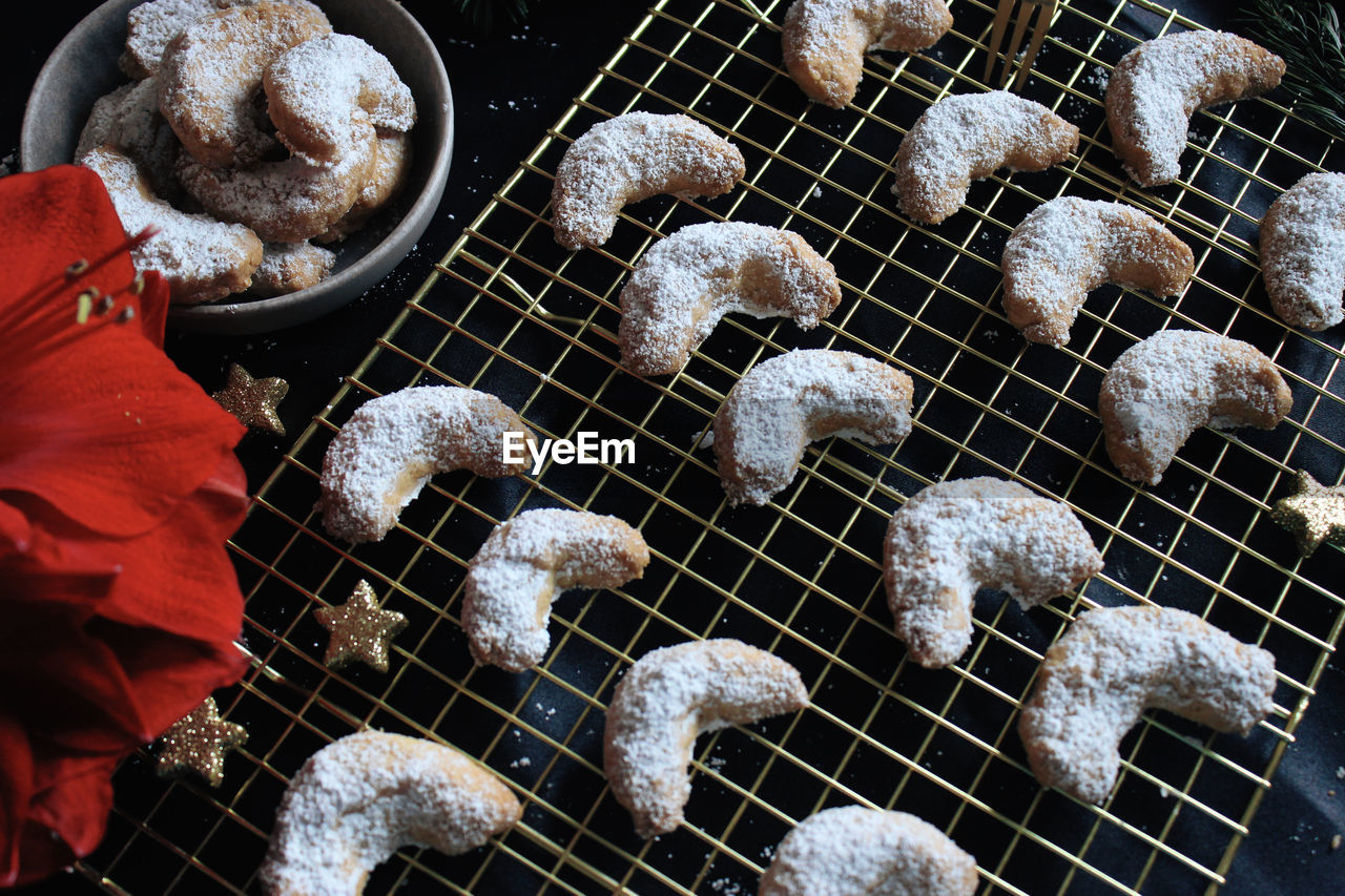 Handmade vanilla crescents on gold cooling grid