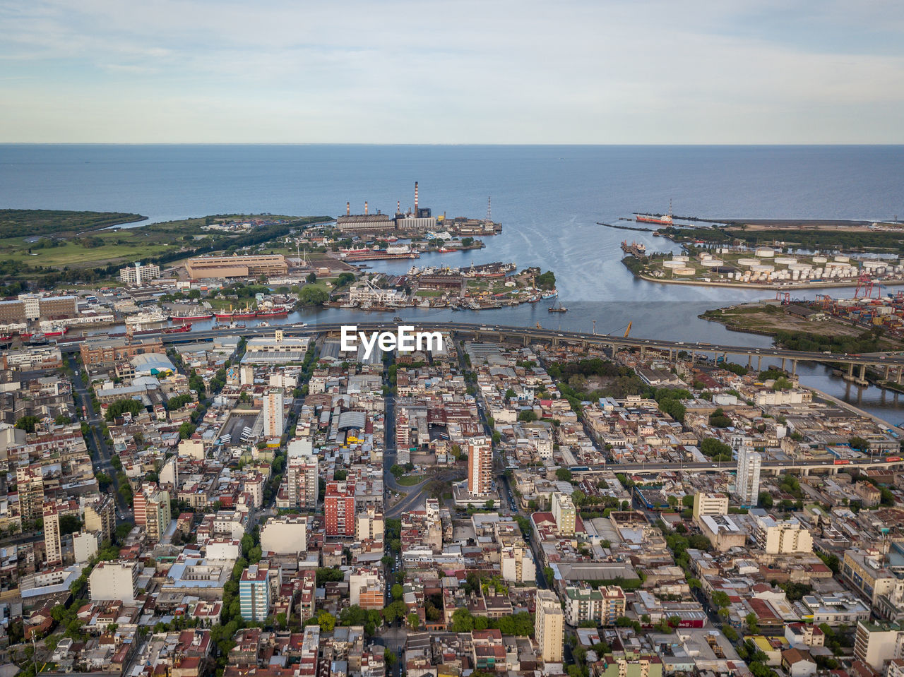 High angle view of town by sea against sky