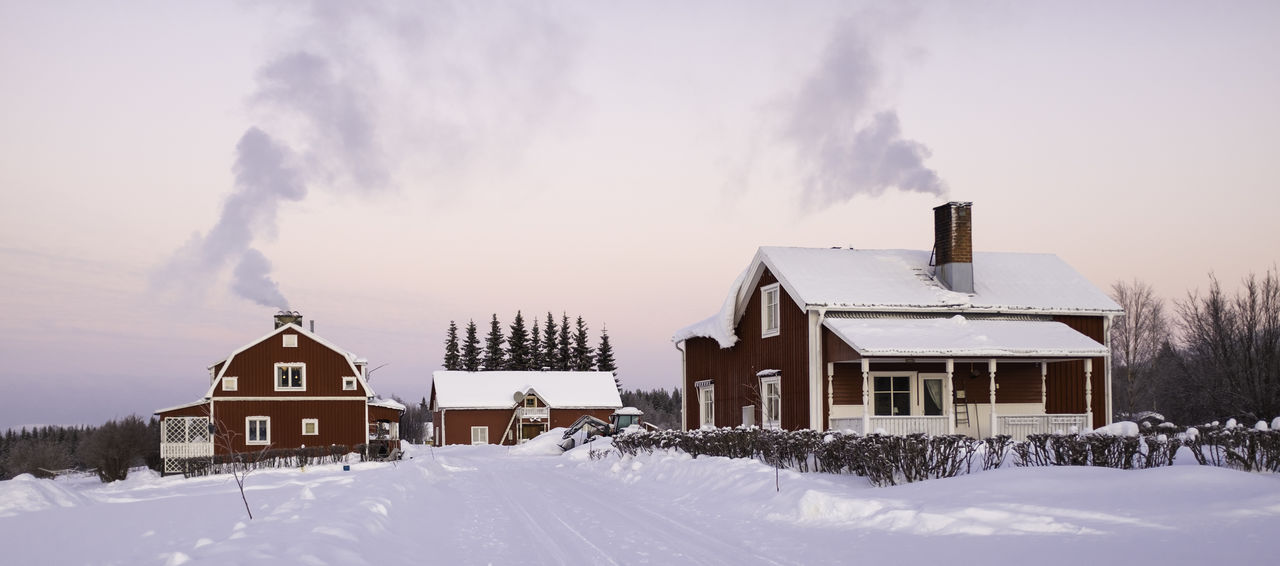 HOUSES ON SNOW AGAINST SKY