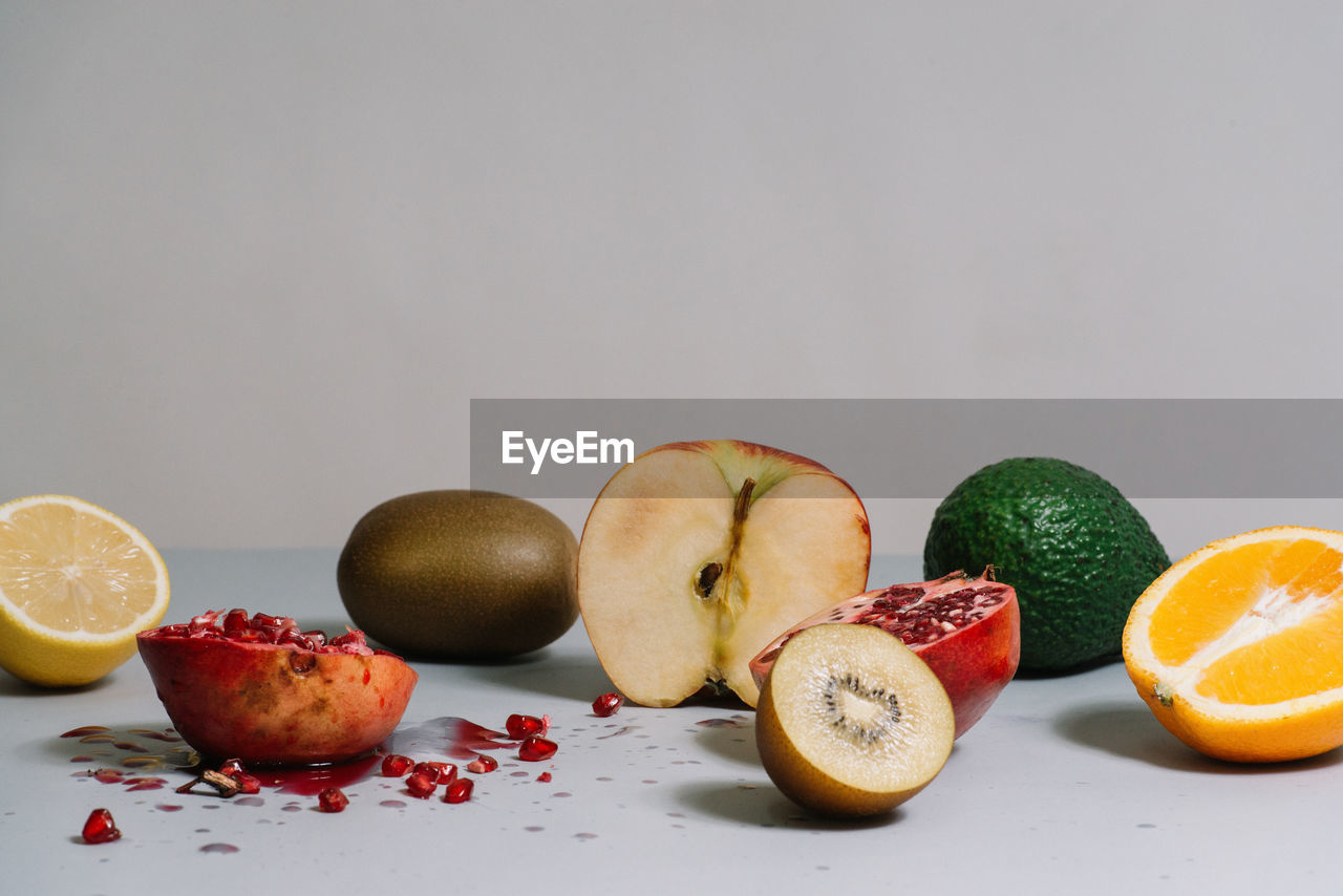 Close-up of fruits on table against gray background
