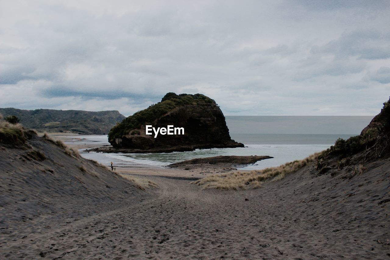 View of beach against cloudy sky