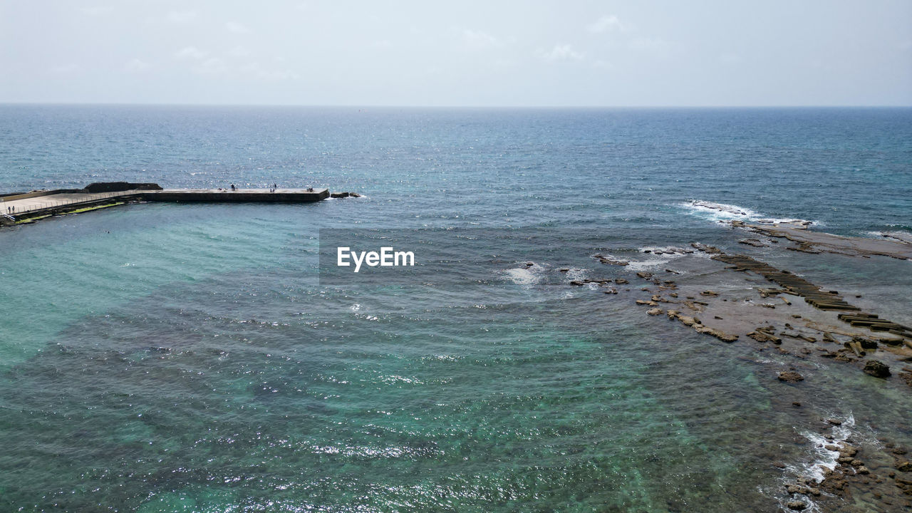 water, sea, scenics - nature, beauty in nature, horizon over water, horizon, sky, nature, tranquility, tranquil scene, land, day, ocean, coast, beach, shore, no people, idyllic, high angle view, nautical vessel, outdoors, transportation, non-urban scene, bay, breakwater, travel