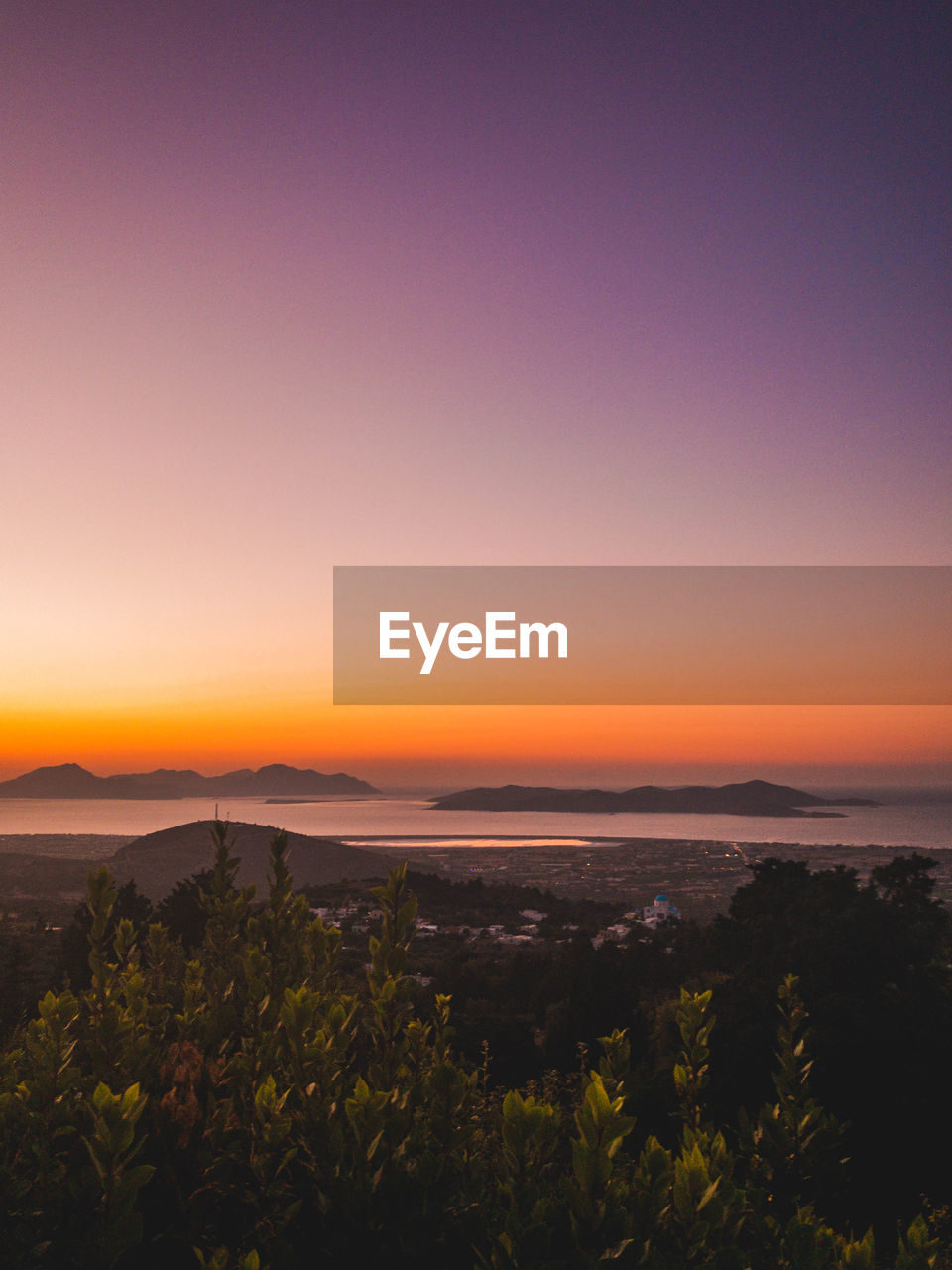 Scenic view of land against sky during sunset