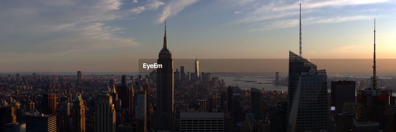 Panoramic view of buildings in city against sky during sunset