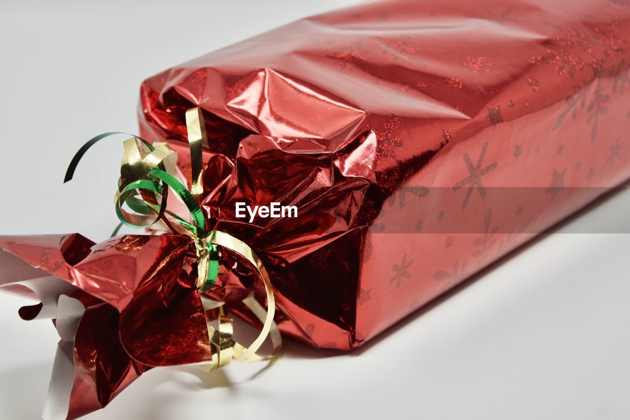 CLOSE-UP OF RED WRAPPED IN BOX