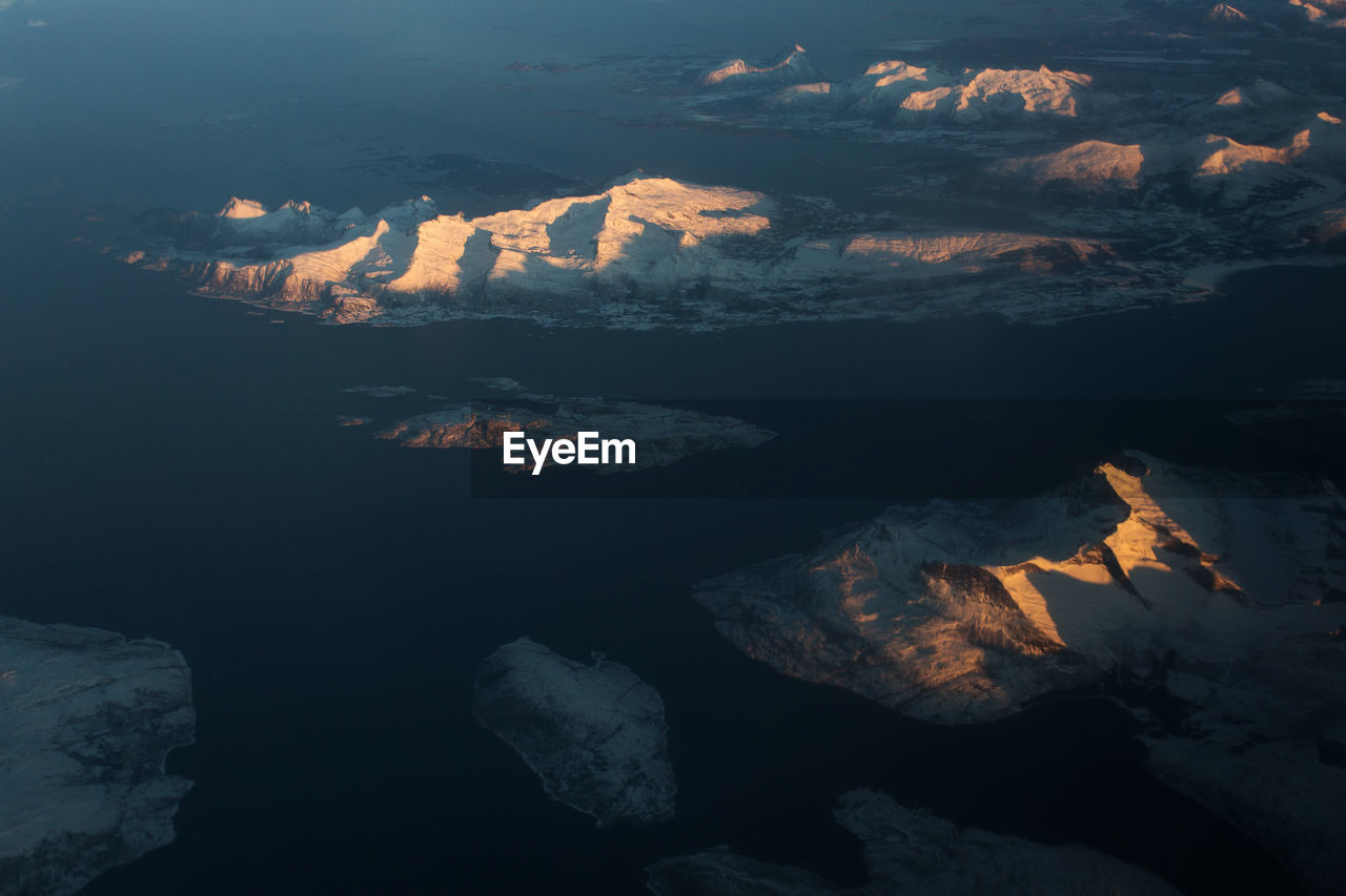 Aerial view of mountain range against sky during sunset