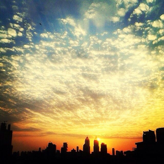 SKYSCRAPERS IN CITY AT SUNSET