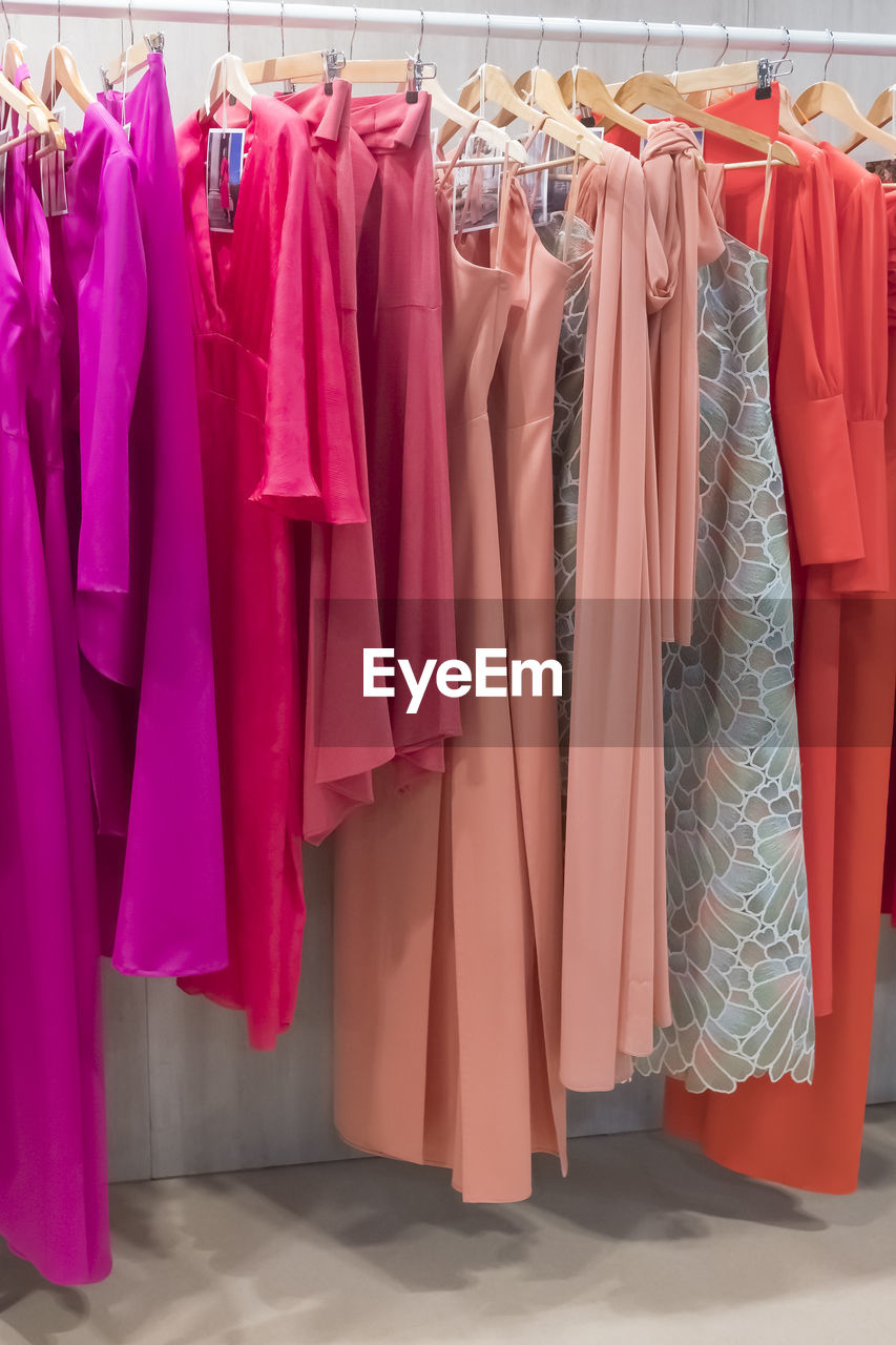 hanging, clothing, coathanger, fashion, rack, pink, shopping, retail, dress, store, variation, no people, clothing store, multi colored, clothes rack, indoors, in a row, room, large group of objects, textile, consumerism, business, sale, boutique, industry, garment, group of objects, elegance