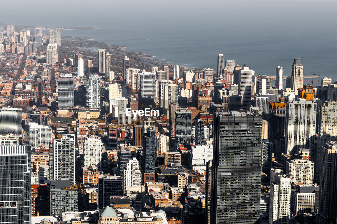 HIGH ANGLE VIEW OF BUILDINGS IN CITY AT WATERFRONT
