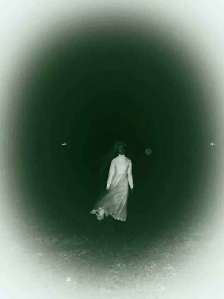 Full length of a young woman walking on road at night