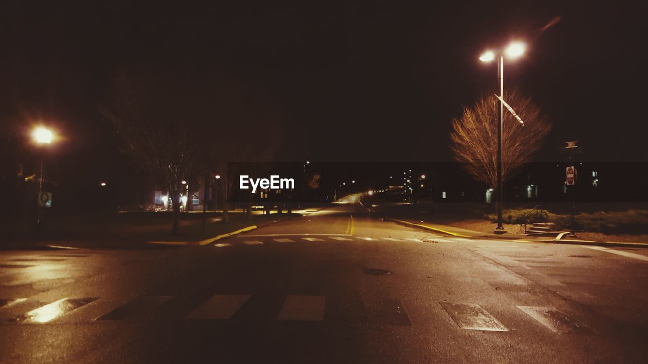 STREET LIGHTS ON ROAD AT NIGHT