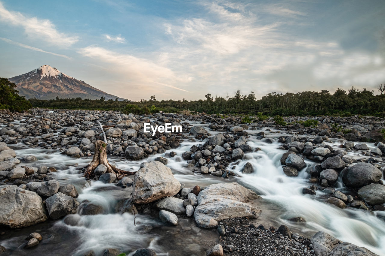 The stoney river flowing from mt taranaki in the golden hour