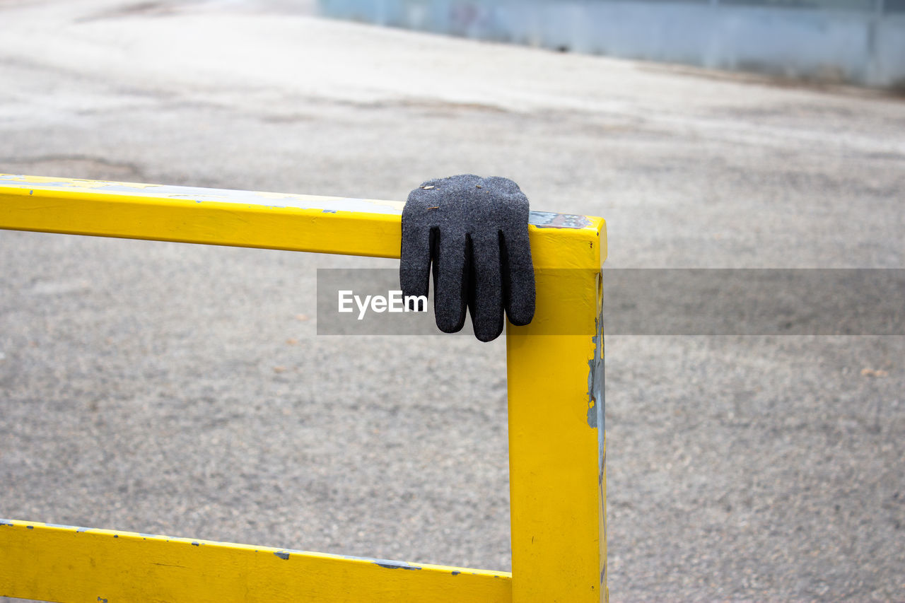Close-up of protective glove on railing