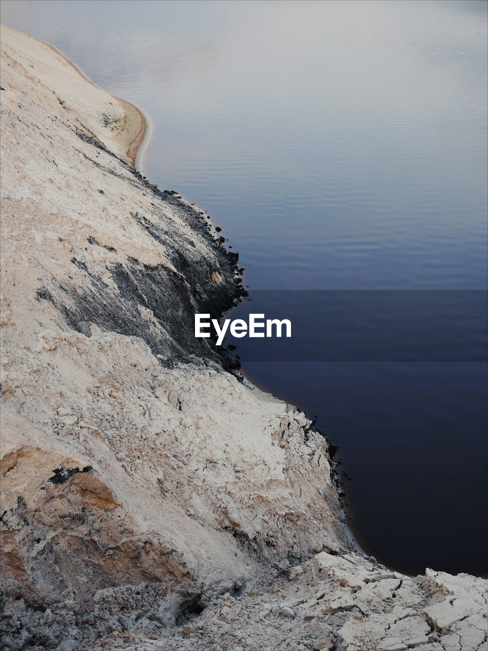 ROCK FORMATION IN SEA AGAINST SKY