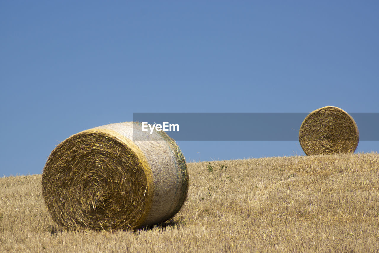 Two round bales of hay in the tuscan countryside
