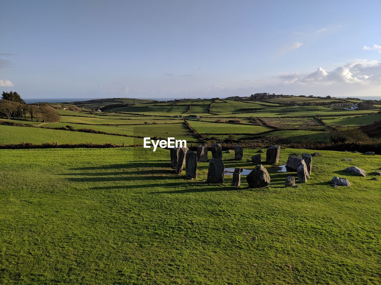 Scenic view of agricultural field against sky at drombeg stone circle in ireland