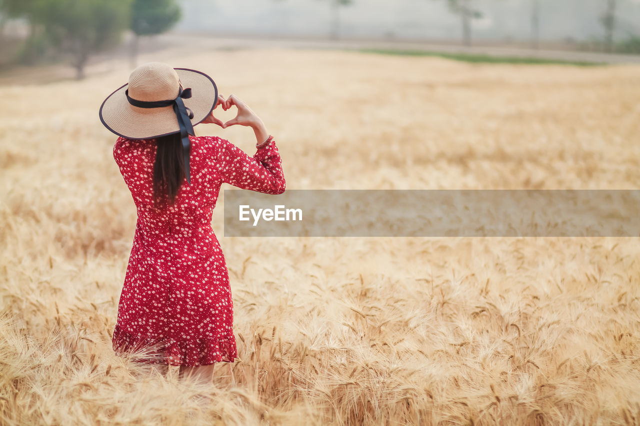 Midsection of woman standing in field