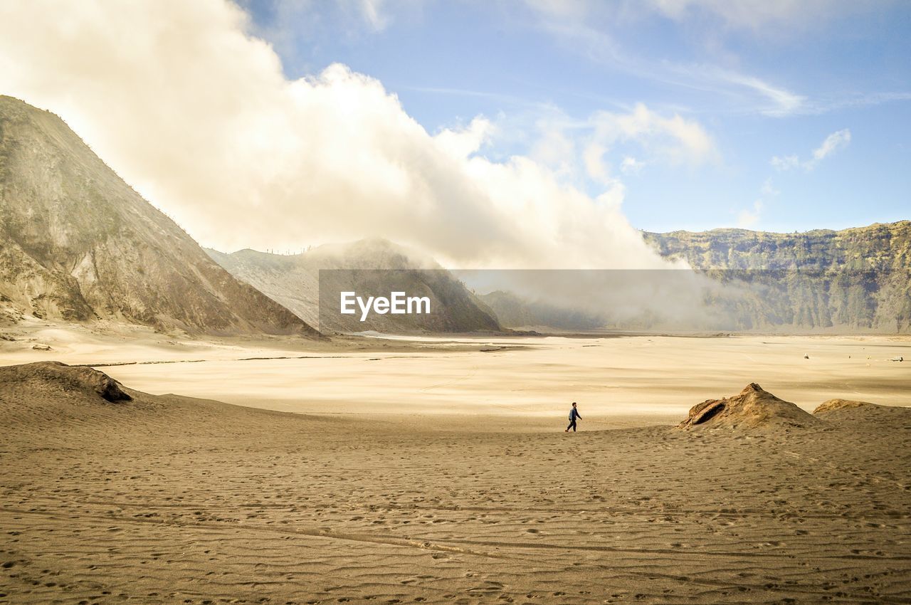 Person on field at mt bromo against sky