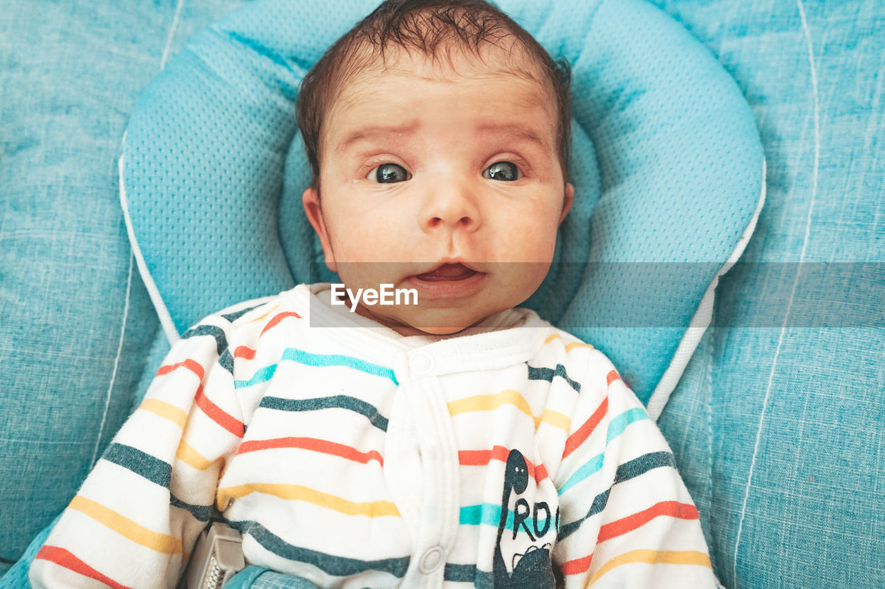 Cute baby girl on bed at home