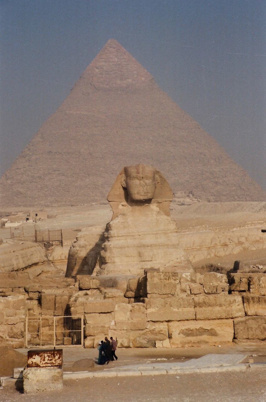 Sphinx with pyramid against clear sky