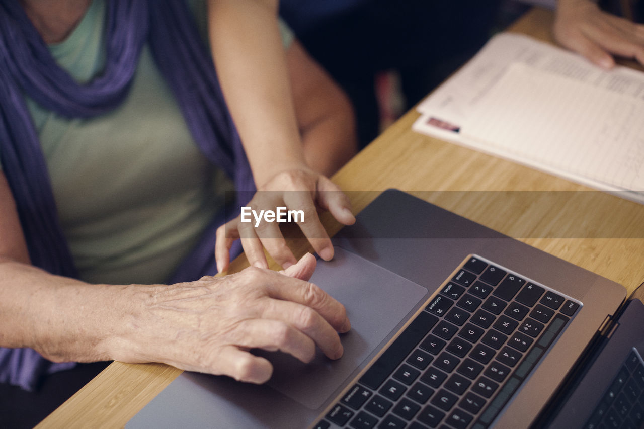 Hands of women using laptop