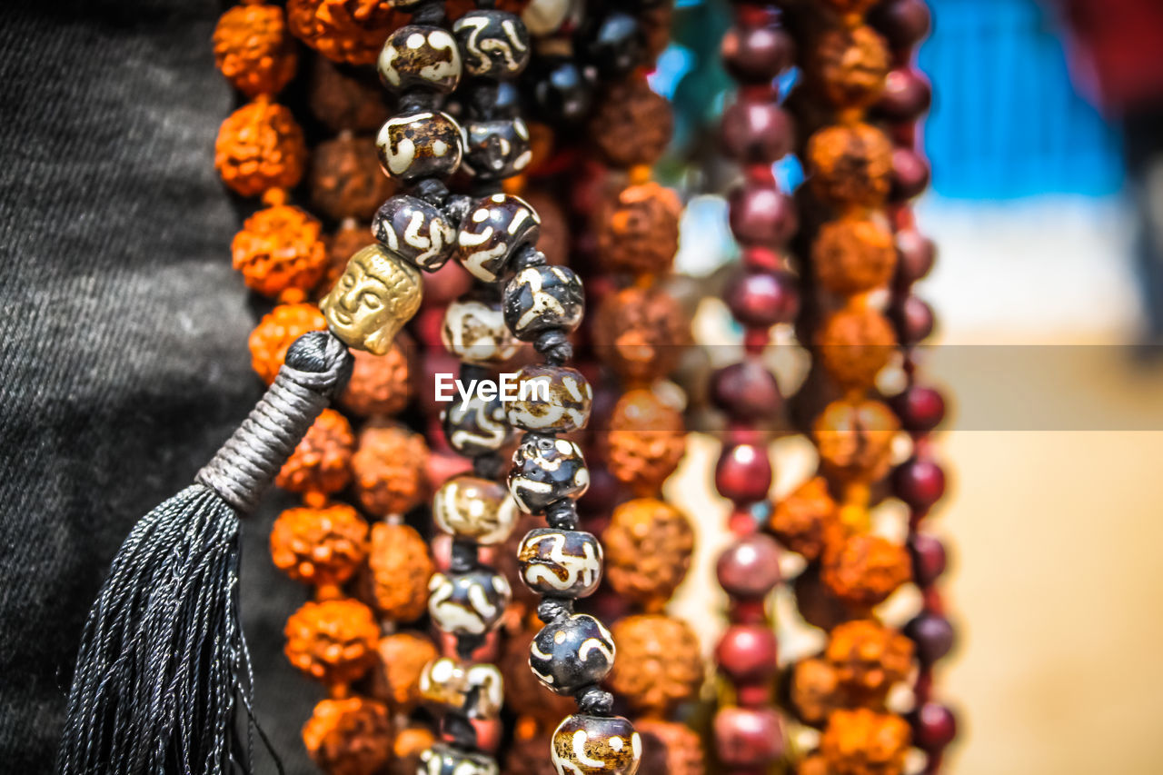 Close-up of multi colored jewelry for sale in market