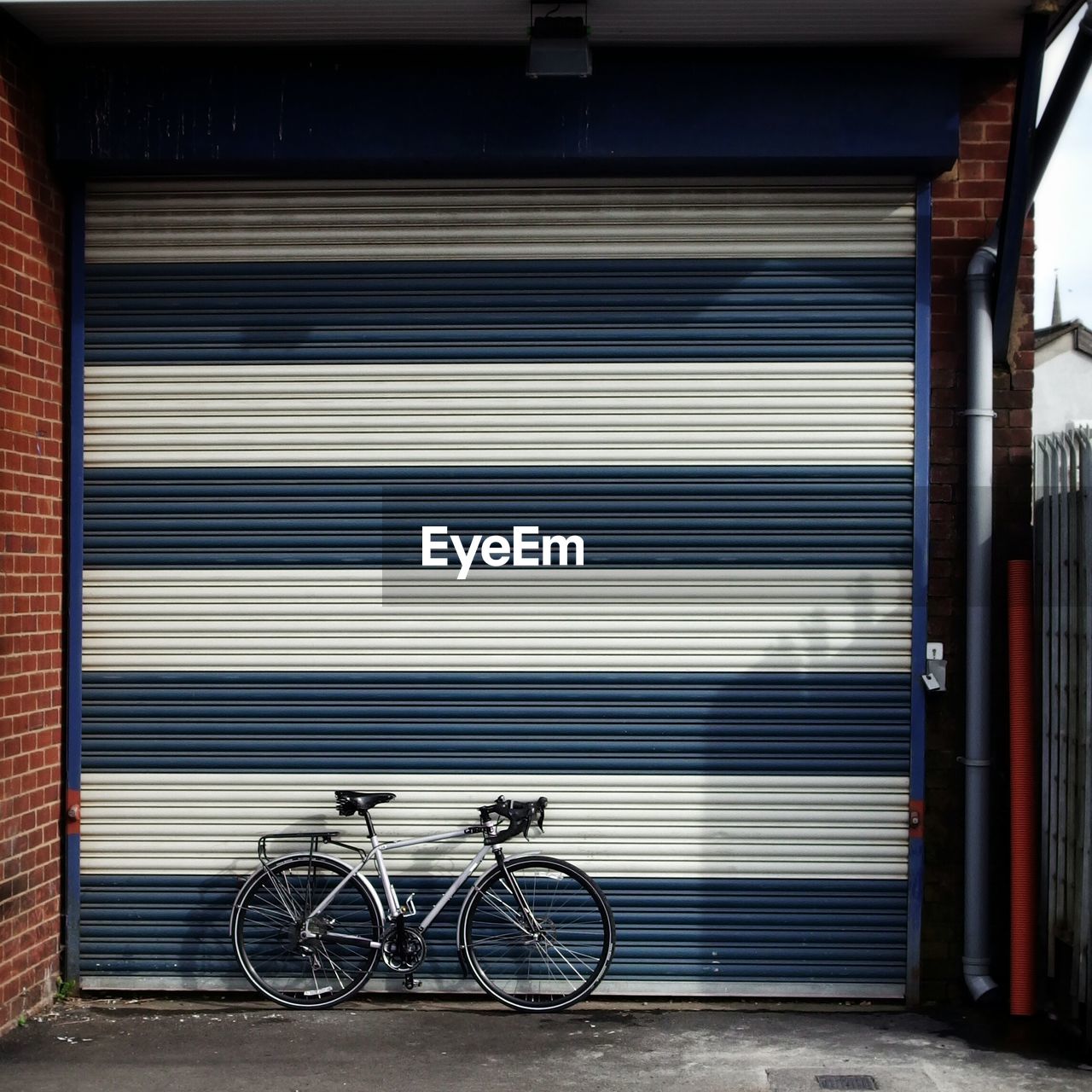 Bicycle leaning against garage door
