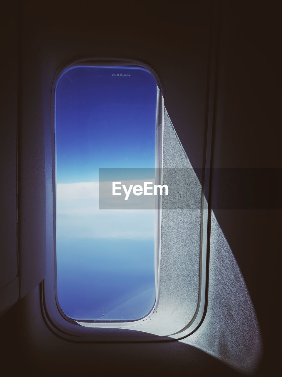 Blue sky seen through airplane window