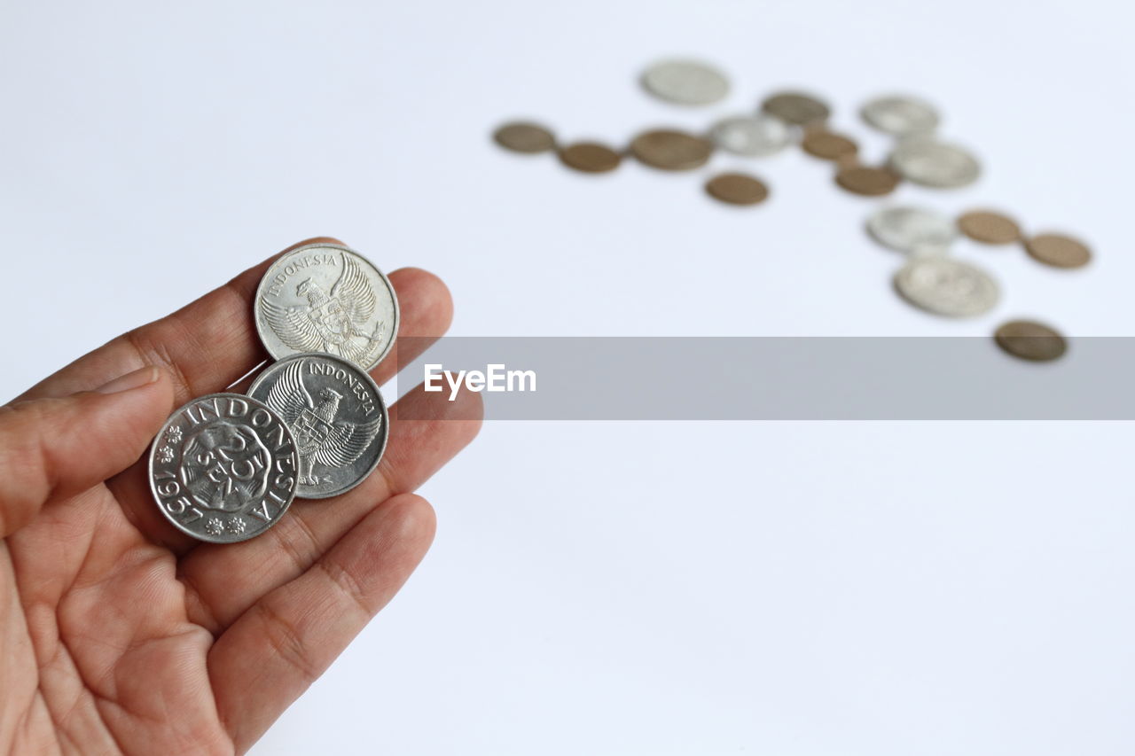 finance, coin, currency, money, hand, wealth, business, savings, holding, investment, one person, money handling, studio shot, cash, large group of objects, finance and economy, jewellery, indoors, economy, white background, paper currency, banking, home finances, close-up, silver, business finance and industry