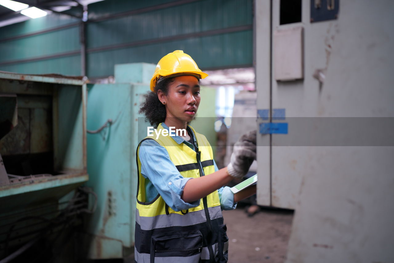 portrait of young man working at construction site