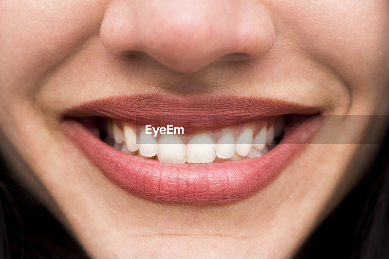 CLOSE-UP OF A SMILING YOUNG WOMAN WITH EYES