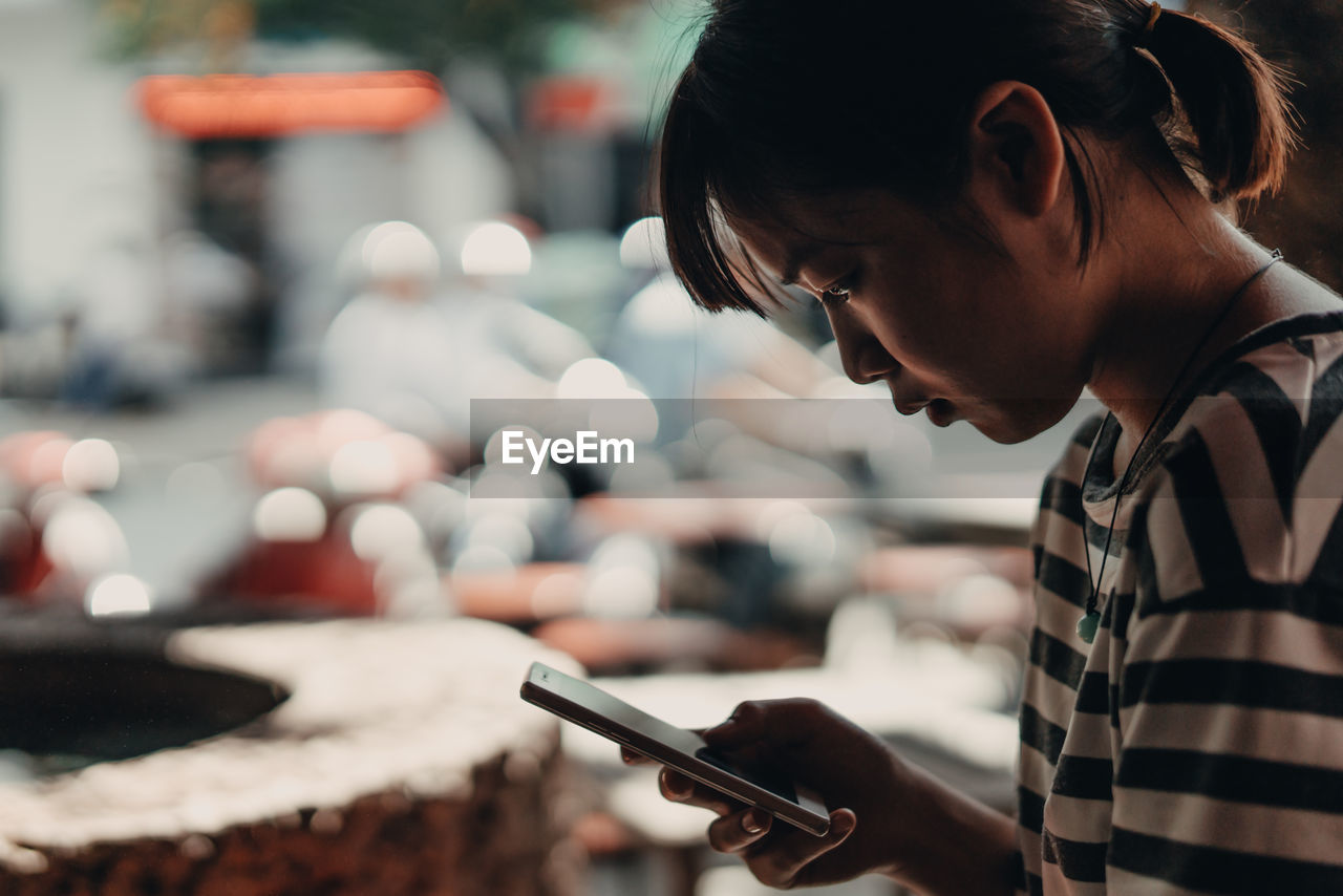 Close-up of woman using mobile phone