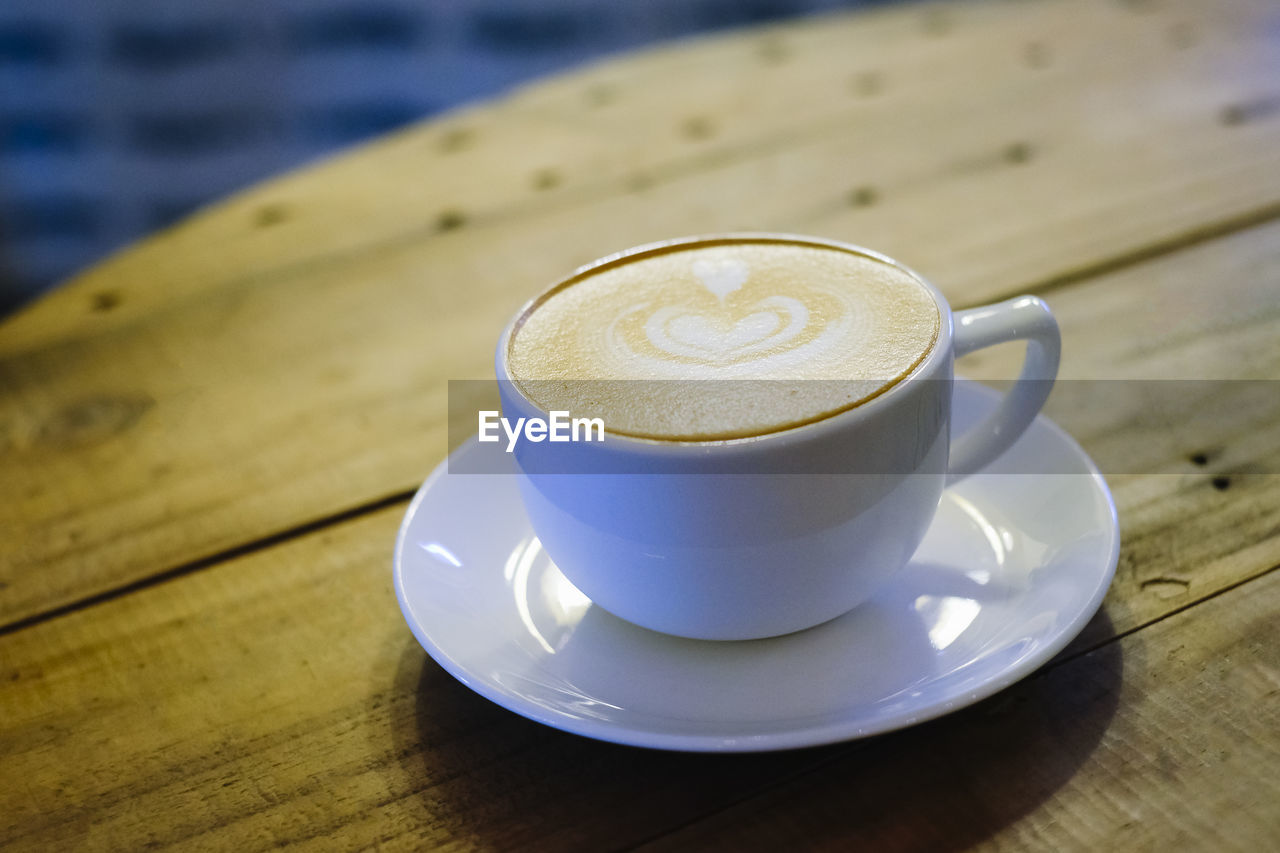 CLOSE-UP OF COFFEE CUP ON TABLE