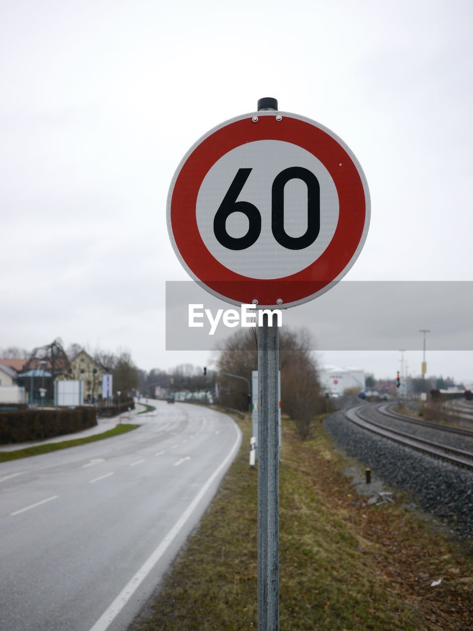 Close-up of speed limit sign against sky