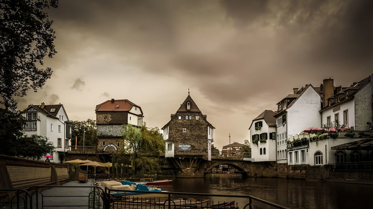 BUILDINGS AGAINST CLOUDY SKY