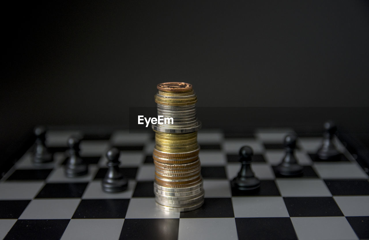 Close-up of coins on chess board