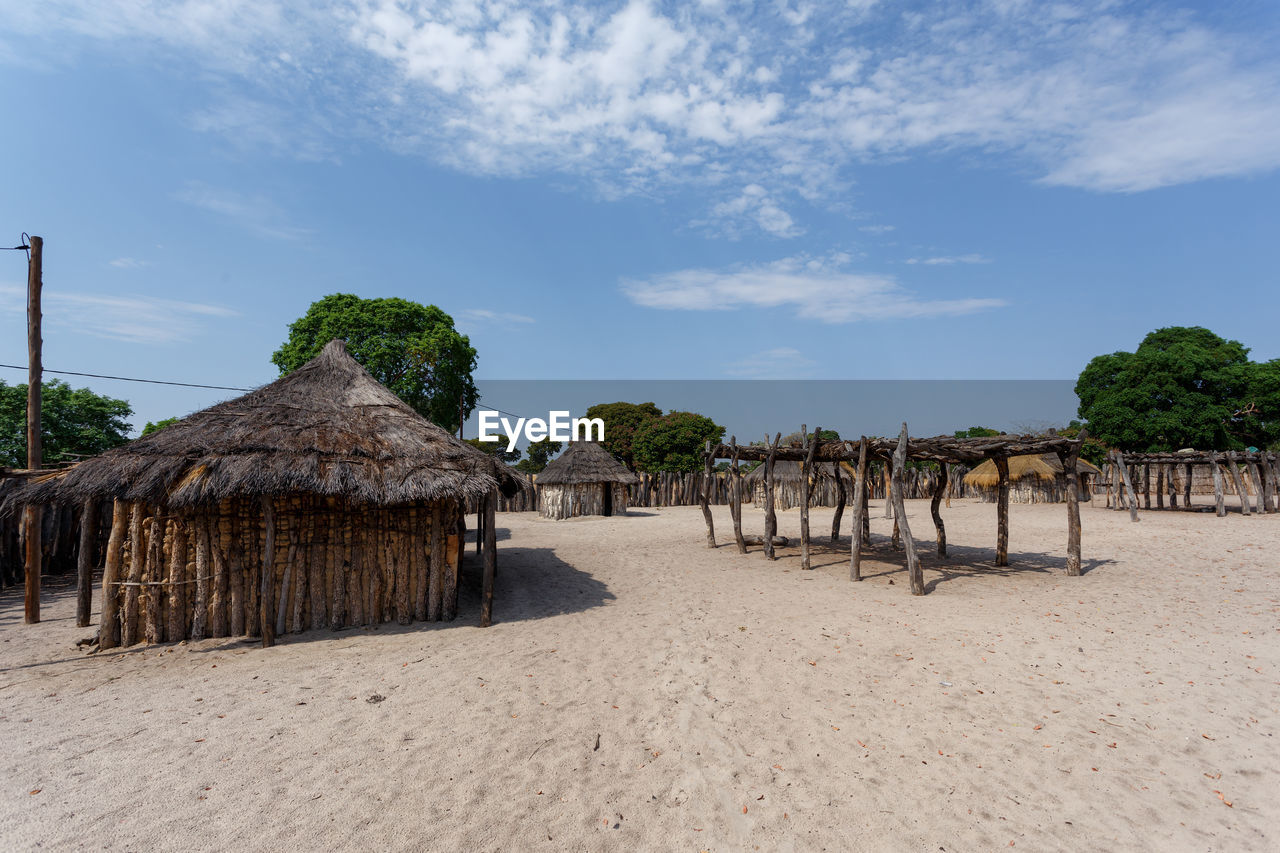 PANORAMIC VIEW OF BEACH AND TREES AGAINST SKY