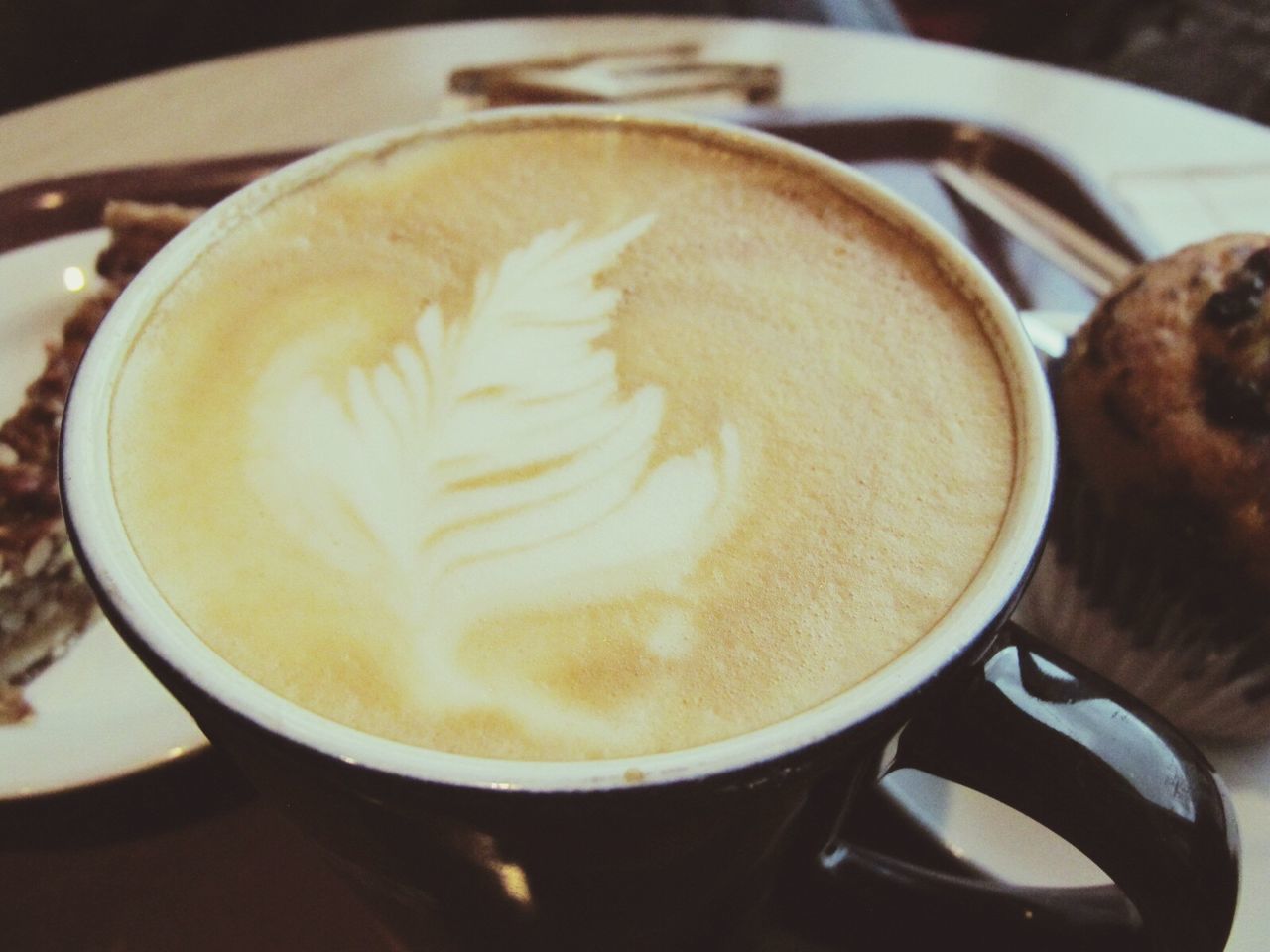 CLOSE-UP OF COFFEE CUP ON TABLE